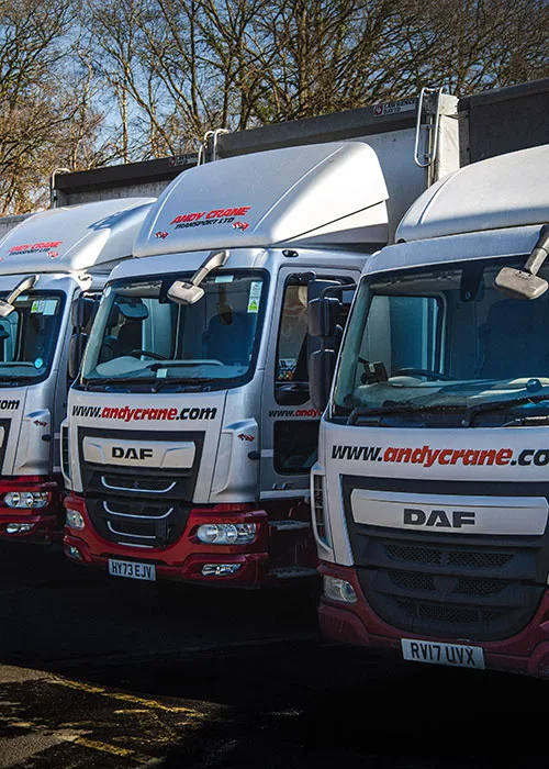 Front view of three trucks lined up, forming part of the Andy Crane Transport fleet