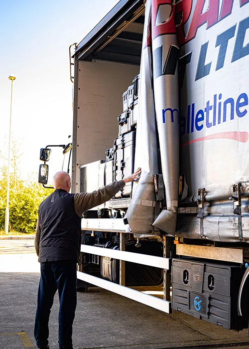 Man sliding open side of truck